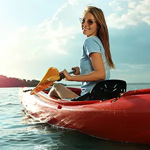 Woman kayaking on lake