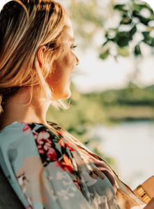 Young woman reading a book by Grand Lake at The Regatta on Grand luxury RV resort near Route 66.