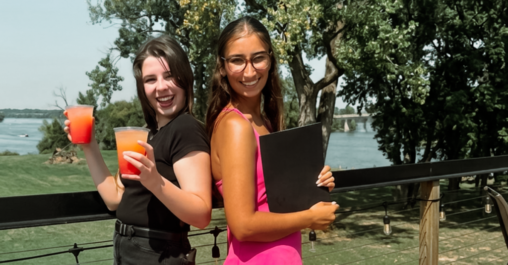 Concierges with drinks and welcome folder at The Regatta on Grand Luxury RV Resort